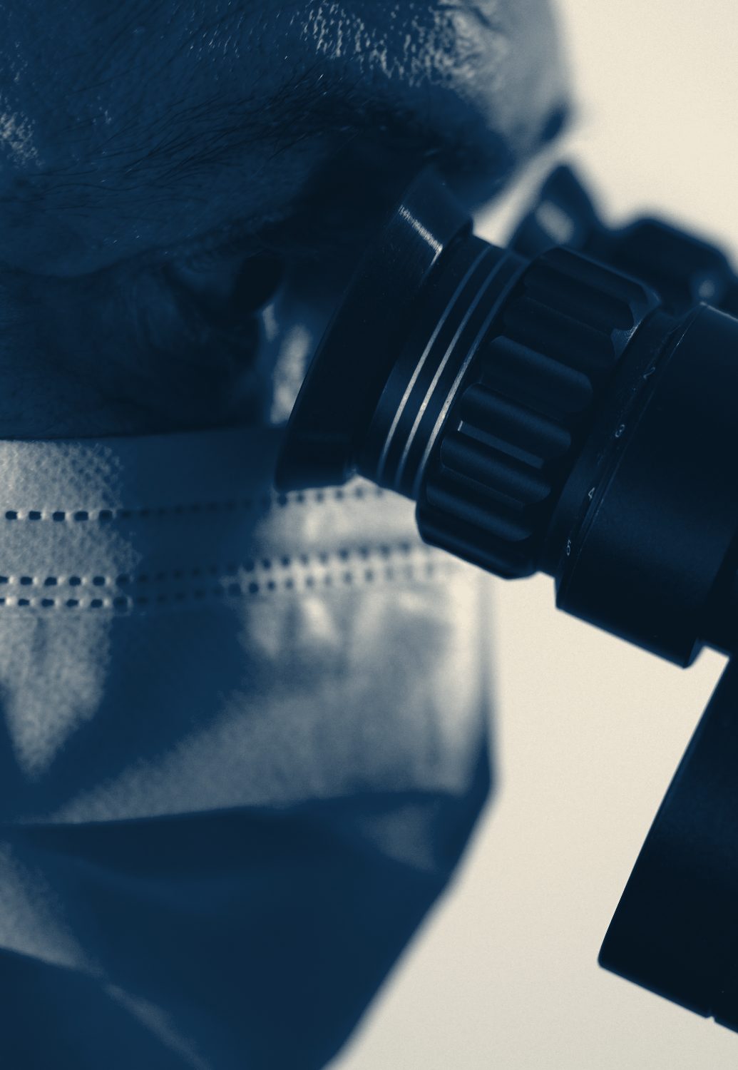 A dentist examining a case through high-magnification dental loupes
